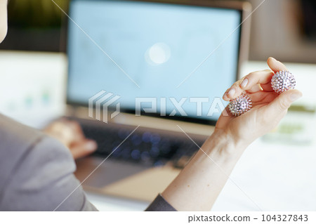 Closeup on modern business woman in grey business suit at work Closeup on modern business woman in grey business suit at work 104327843