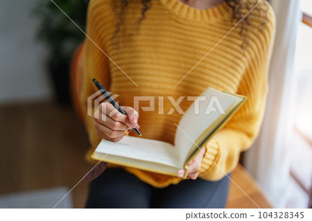 woman holding a pen to write down memories. woman holding a pen to write down memories. 104328345
