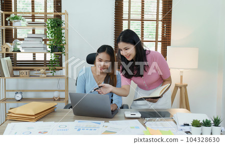 Financial analysts analyzing business reports on planned investment projects during corporate meeting discussions showcase successful teamwork with marketing plan, computers and calculators to work. 104328630