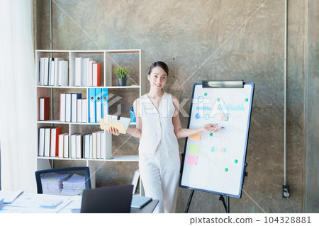Portrait of young asian woman holding notebook with presentation of strategy, investment plan and marketing 104328881