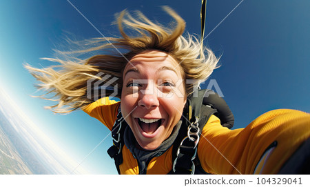 Young woman parachutist smiling in free fall. Perfect concept of happiness and freedom. 104329041
