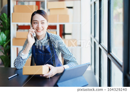 Starting small business entrepreneur of independent Asian female online seller packing products to send to customers and SME delivery concept. Starting small business entrepreneur of independent Asian female online seller packing products to send to customers and SME delivery concept. 104329240