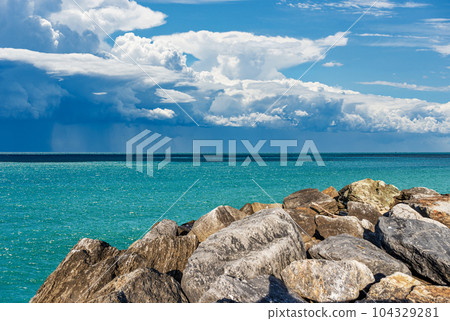Breakwater and Seascape with Storm Clouds and Torrential Rain Breakwater and Seascape with Storm Clouds and Torrential Rain 104329281