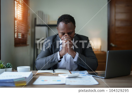 Burnout American African business man in stress works with many paperwork document, migraine attack, Freelance, work from home. Burnout American African business man in stress works with many paperwork document, migraine attack, Freelance, work from home. 104329295