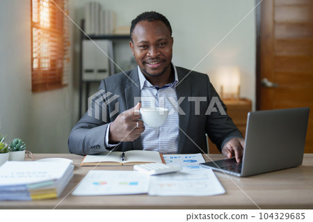middle aged man American African using computer laptop with planning working on financial document, tax, exchange, accounting and Financial advisor. middle aged man American African using computer laptop with planning working on financial document, tax, exchange, accounting and Financial advisor. 104329685