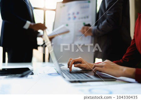 Team business adviser meeting to analyze and discuss the situation on the financial report n the meeting room with using computer laptop, documents, calculator in work 104330435