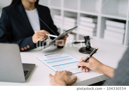 Legal counsel presents to the client a signed contract with legal law. justice and lawyer concept in office. Legal counsel presents to the client a signed contract with legal law. justice and lawyer concept in office. 104330554