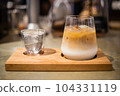 a cup of ice latte coffee and cold water on Wooden tray 104331119