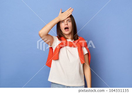 Portrait of sad upset beautiful woman wearing casual style clothing standing isolated over blue background, showing facepalm gesture, forgot something important. Portrait of sad upset beautiful woman wearing casual style clothing standing isolated over blue background, showing facepalm gesture, forgot something important. 104331135