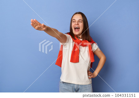 Portrait of positive excited Caucasian happy woman wearing casual style clothing standing isolated over blue background, raised her arm, pretending to be superhero. Portrait of positive excited Caucasian happy woman wearing casual style clothing standing isolated over blue background, raised her arm, pretending to be superhero. 104331151