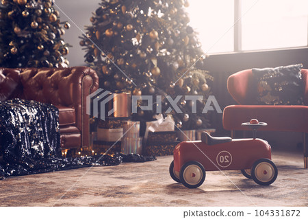 On the background of the window is a Christmas interior and a large toy car. Several Christmas trees decorated with bright garlands and golden balls. High quality photo On the background of the window is a Christmas interior and a large toy car. Several Christmas trees decorated with bright garlands and golden balls. High quality photo 104331872