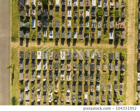 Top view on a Cemetery in Strasbourg. Aerial view at Graves at sunny day. Pattern of tombs and grave trails 104331952