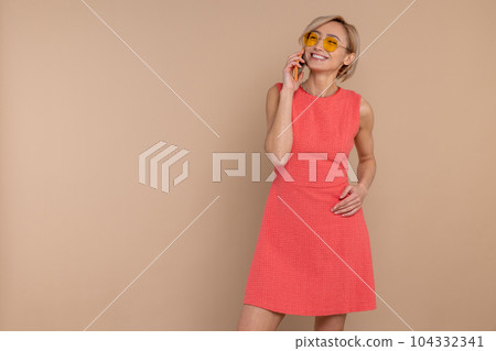 Happy smiling woman in dress and sunglasses talking mobile phone Happy smiling woman in dress and sunglasses talking mobile phone 104332341