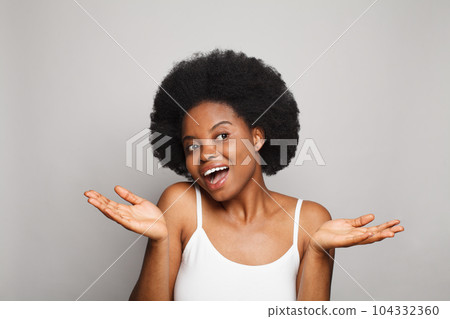 Happy woman presenting with empty open hand holding something blank isolated on white background  104332360