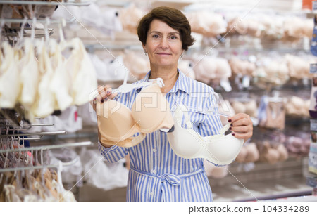 Elderly retired senora buying bra in lingerie section of the supermarket 104334289