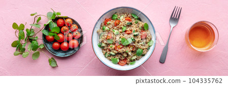 Quinoa tabbouleh salad in a bowl, a healthy dinner with tomatoes and mint Quinoa tabbouleh salad in a bowl, a healthy dinner with tomatoes and mint 104335762