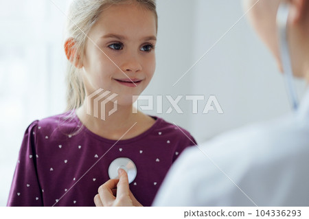 Child girl patient at usual medical inspection. Doctor and kid patient at home. Medicine, healthcare concepts 104336293