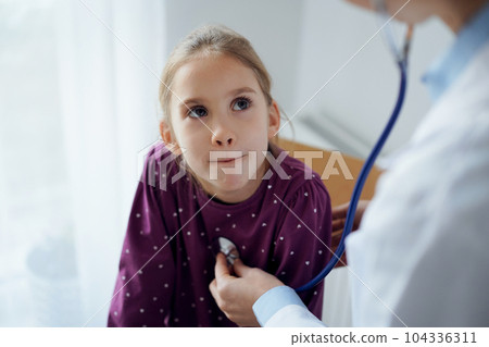 Child patient at usual medical inspection. Doctor and kid girl patient at home. Medicine, healthcare concepts Child patient at usual medical inspection. Doctor and kid girl patient at home. Medicine, healthcare concepts 104336311