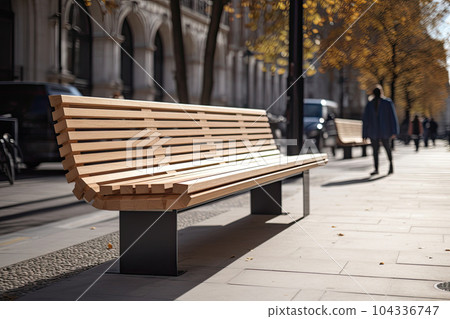 Modern wooden benches standing on the sides of the paved paths of the city park on a rainy day 104336747