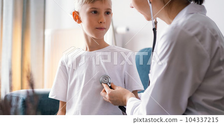 Doctor and kid boy at home. Child patient at usual medical inspection. Medicine, healthcare concepts 104337215