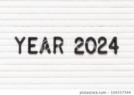 Black color letter in word year 2024 on white felt board background Black color letter in word year 2024 on white felt board background 104337344
