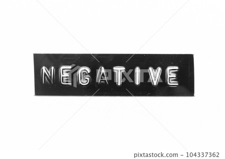 Black color banner that have embossed letter with word negative on white paper background 104337362