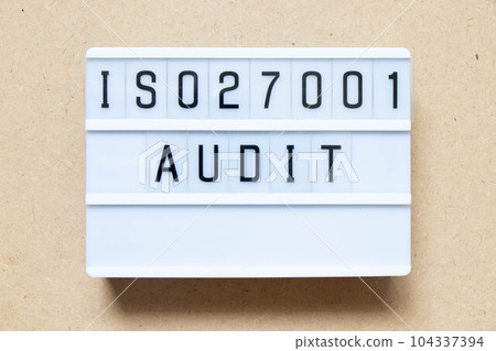 Lightbox with word ISO 270001 audit on wood background 104337394