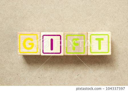 Wooden alphabet letter block in word gift on wood background 104337397