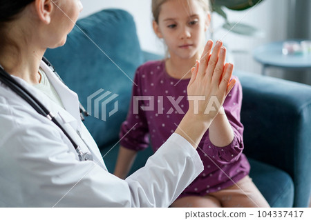 Doctor and kid patient giving Five to each other at home. Child patient at usual medical inspection. Medicine, healthcare concepts 104337417