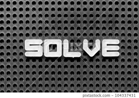 White alphabet letter in word solve on black pegboard background 104337431