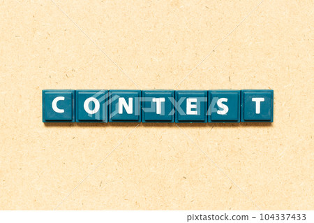 Tile alphabet letter in word contest on wood background Tile alphabet letter in word contest on wood background 104337433