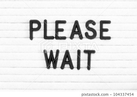 Black color letter in word please wait on white felt board background Black color letter in word please wait on white felt board background 104337454