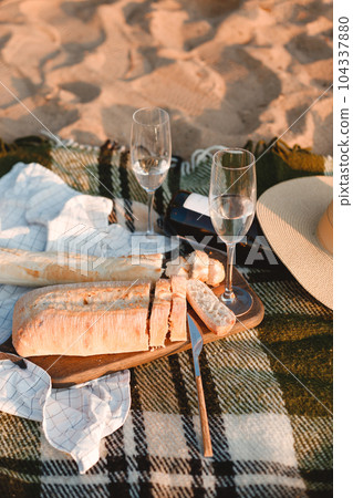 Beautiful romantic summer picnic with two glasses of white wine, ciabatta Beautiful romantic summer picnic with two glasses of white wine, ciabatta 104337880