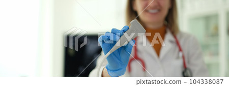 Smiling woman ultrasound diagnostic doctor holding transducer in clinic closeup Smiling woman ultrasound diagnostic doctor holding transducer in clinic closeup 104338087