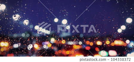 Driving in raining. Rain on car windshield or car window in rainy season and blurry traffic road in background. Rain drops on car mirror. Road in rain. Drizzle raining decreases driving visibility. Driving in raining. Rain on car windshield or car window in rainy season and blurry traffic road in background. Rain drops on car mirror. Road in rain. Drizzle raining decreases driving visibility. 104338372
