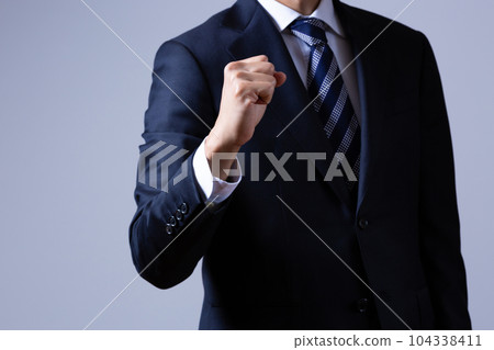 Male businessman doing guts pose Male businessman doing guts pose 104338411