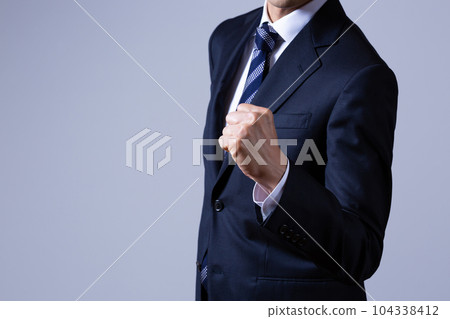 Male businessman doing guts pose Male businessman doing guts pose 104338412