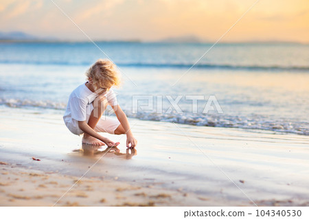 Kids play on tropical beach. Sand and water toy. Kids play on tropical beach. Sand and water toy. 104340530