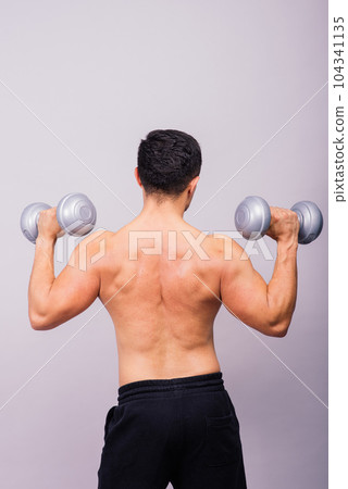 Shirtless bodybuilder showing his great body and holding dumbell. Shirtless bodybuilder showing his great body and holding dumbell. 104341135