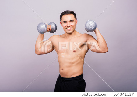 Shirtless bodybuilder showing his great body and holding dumbell. Shirtless bodybuilder showing his great body and holding dumbell. 104341137