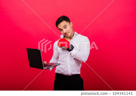 Guy in boxing gloves and formalwear punch computer isolated on red, cyber bullying. 104341141