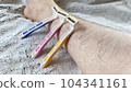 Pink, yellow and blue disposable razors and hairy female legs 104341161