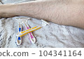 Pink, yellow and blue disposable razors and hairy female legs 104341164