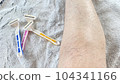 Pink, yellow and blue disposable razors and hairy female legs 104341166