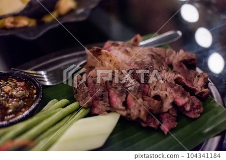 Medium rare meat served on the plate with sauce 104341184