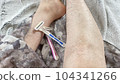 Close-up of blue and pink disposable razor and hairy woman 104341266