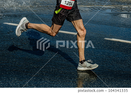 legs male runner running marathon race in puddle, sports summer games legs male runner running marathon race in puddle, sports summer games 104341335