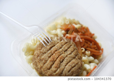 Delicious breakfast in a container. Breakfast with vermicelli fried cutlet and vegetables. 104341370