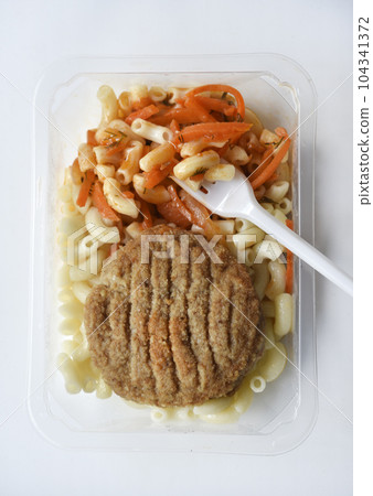 Delicious breakfast in a container. Breakfast with vermicelli fried cutlet and vegetables. Delicious breakfast in a container. Breakfast with vermicelli fried cutlet and vegetables. 104341372