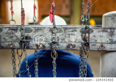 Close-up detail view old rusty chain lock row at miner's clothing room hall against jobeless miner abandoned ore mine Rammelsberg Goslar Harz Germany. Unemployement and industry recession background 104341408